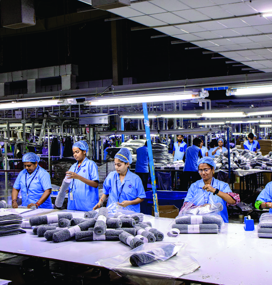 Workers folding garments on a factory floor
